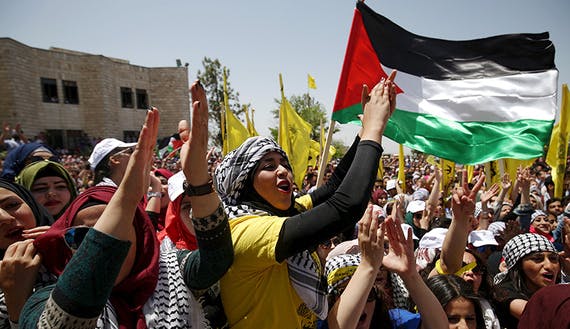 Palestinian students supporting Fatah movement take part in a rally during an election campaign for the student council at the Birzeit University in the West Bank city of Ramallah
