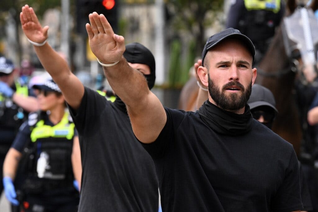 Thomas Sewell leads a Nazi salute as neo-Nazi and transgender rights supporters face off at a demonstration in Melbourne on &nbsp;Saturday. (AAP Image/James Ross)&nbsp;
