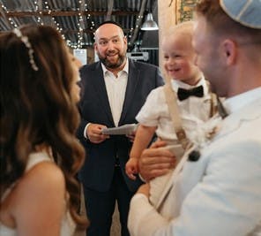 Rabbi Gersh Lazarow conducts a wedding which includes the couple's child.