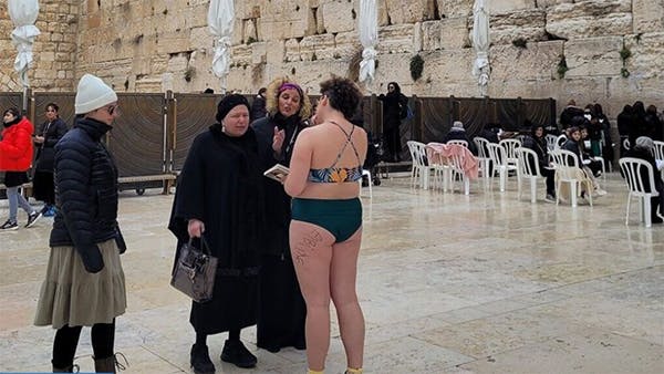A woman stripped down to her swimsuit to protest an attempt to restrict women's clothing at the Western Wall