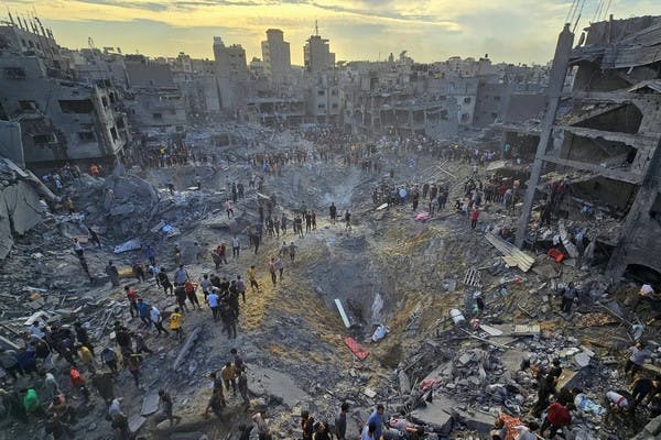 Palestinians search for casualties from a strike on the Jabaliya refugee camp, October 31 (Reuters)