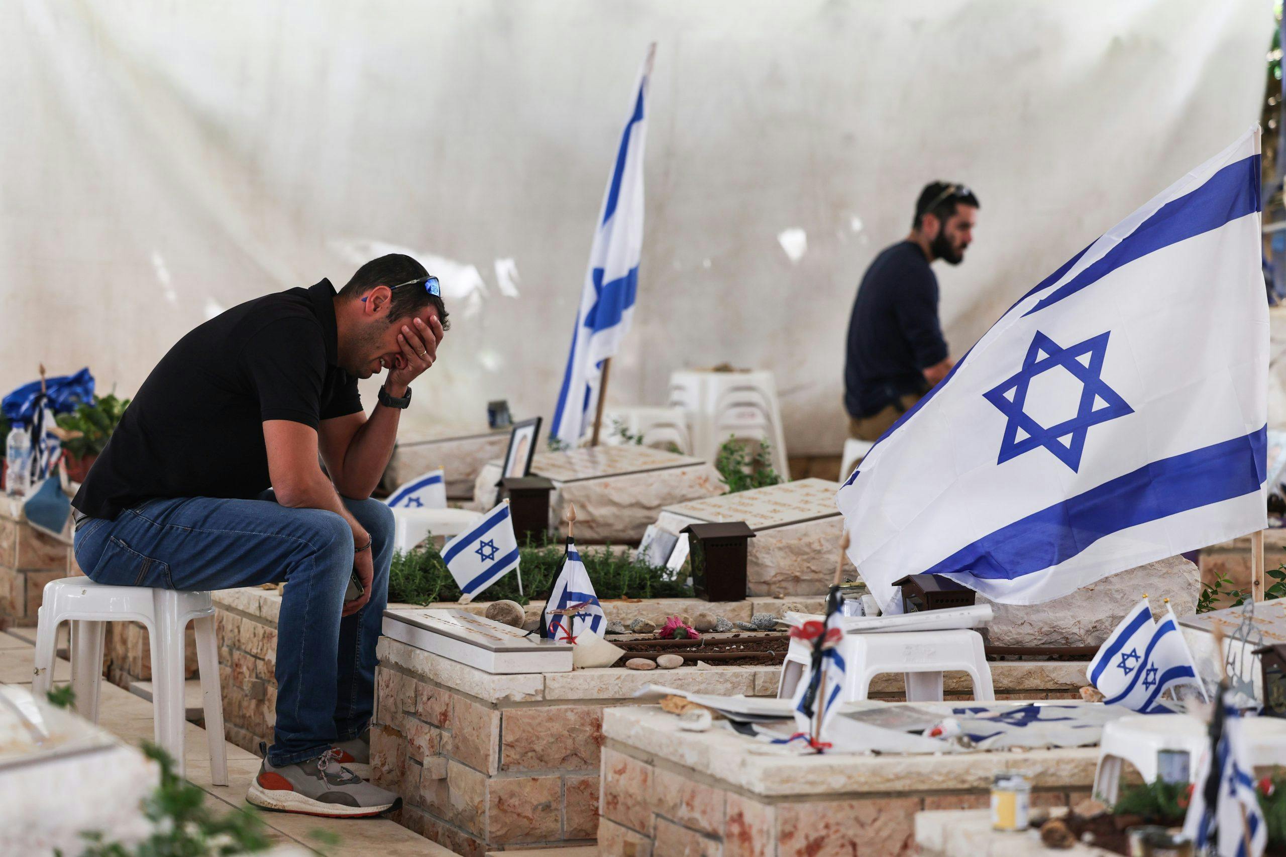 A relative mourns at the new burial plot graves of fallen Israeli soldiers at Israel's national military cemetery Mount Herzl in Jerusalem on 12 May 2024 (Image: EPA/ABIR SULTAN).