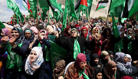 Palestinians supporting Hamas chant slogans during a rally celebrating the winning of the student council election at Birzeit University in the West Bank city of Ramallah