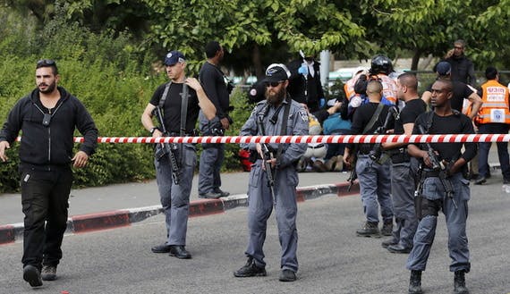 Israeli policemen stand guard at the scene of a stabbing attack in Jerusalem