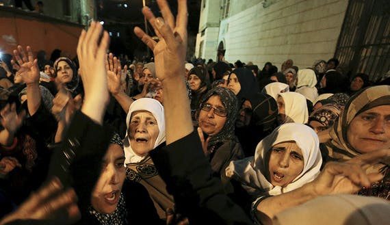 Women mourn during the funeral of Palestinian Ahmed Zakarna in the West Bank town of Qabatya, near Jenin